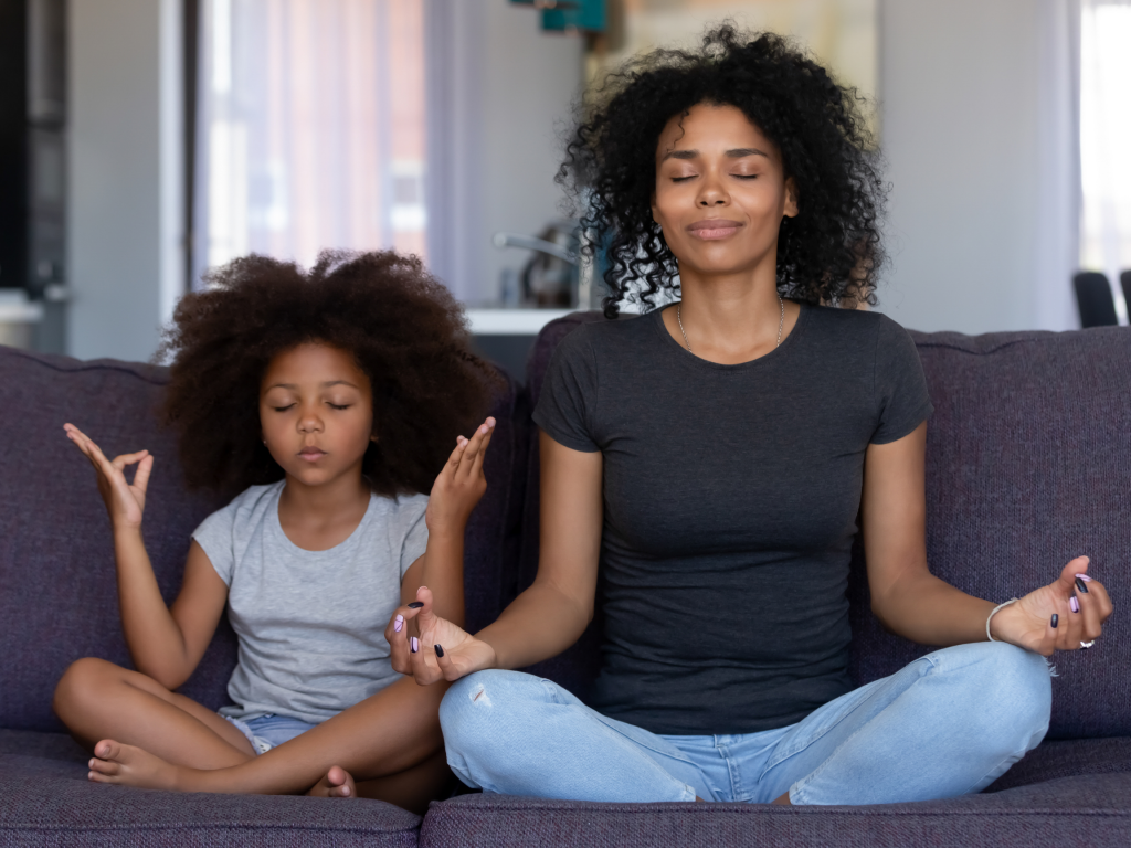 mother and daughter practicing light yoga at home.